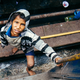 A boy begs for money between cars at Guwahati Junction, Assam.